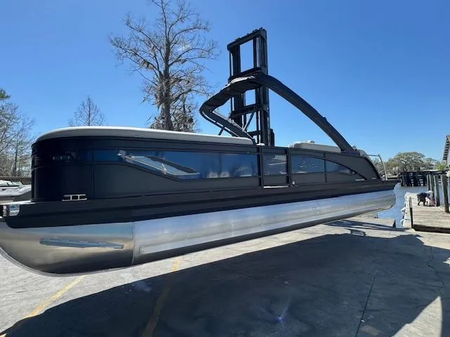Slide: The Image of 2025 Barletta CORSA 25MA pontoon boat displayed outdoors on a sunny day. - 2