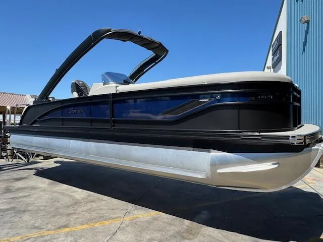 Slide: The Image of 2025 Barletta CORSA 25MA pontoon boat with sleek design, docked outdoors. - 1