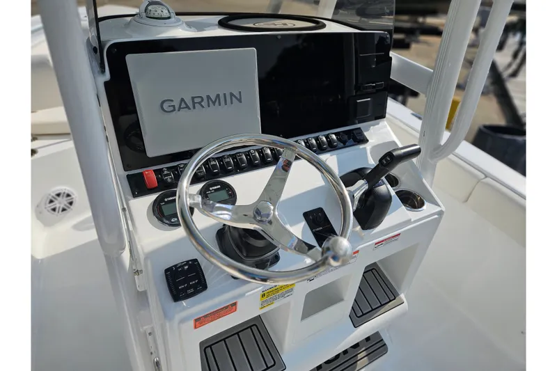 Slide: The Image of 2027 Sea Hunt Ultra 219 boat console with Garmin navigation system and steering wheel. - 21