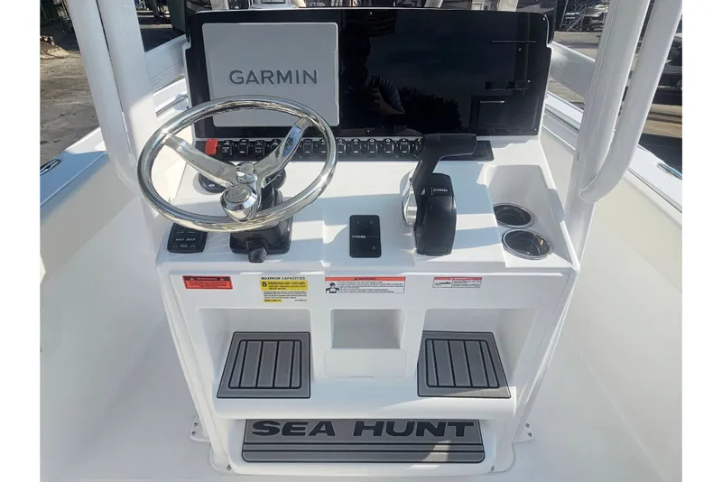 Slide: The Image of 2027 Sea Hunt Ultra 219 boat console with Garmin display and steering wheel. - 20