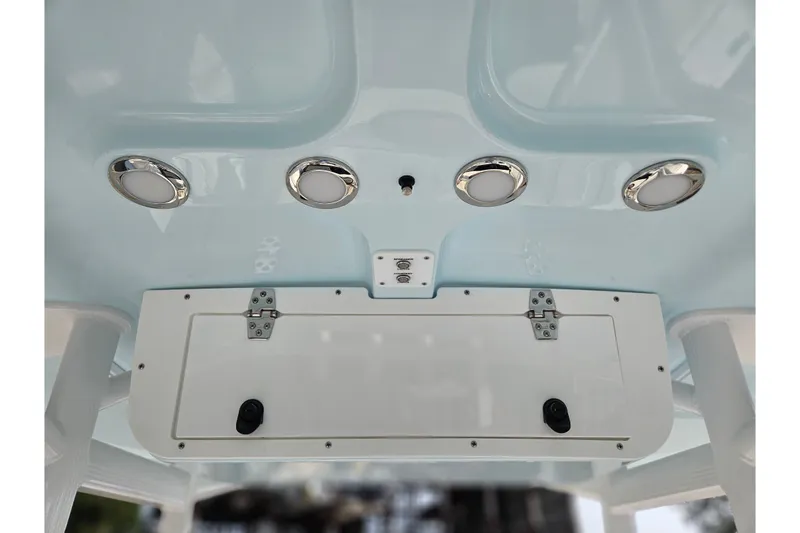 Slide: The Image of Ceiling view of 2027 Sea Hunt Ultra 219 boat with lights and storage compartment. - 22