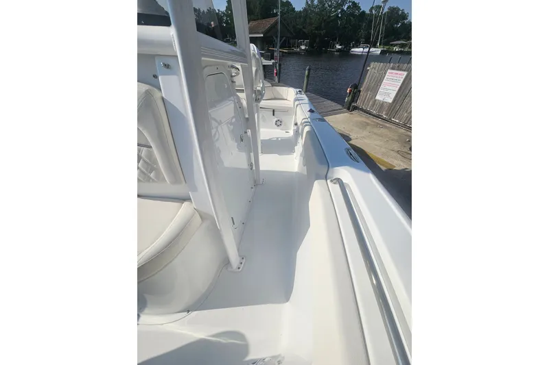 Slide: The Image of 2027 Sea Hunt Ultra 219 boat interior with white seating and sleek design. - 31