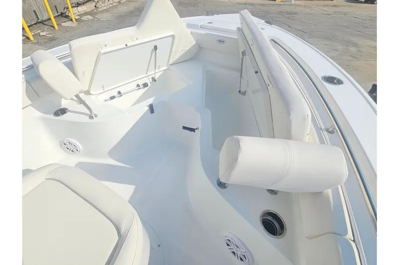 Slide: The Image of 2027 Sea Hunt Ultra 219 boat interior with white seating and storage compartments. - 28