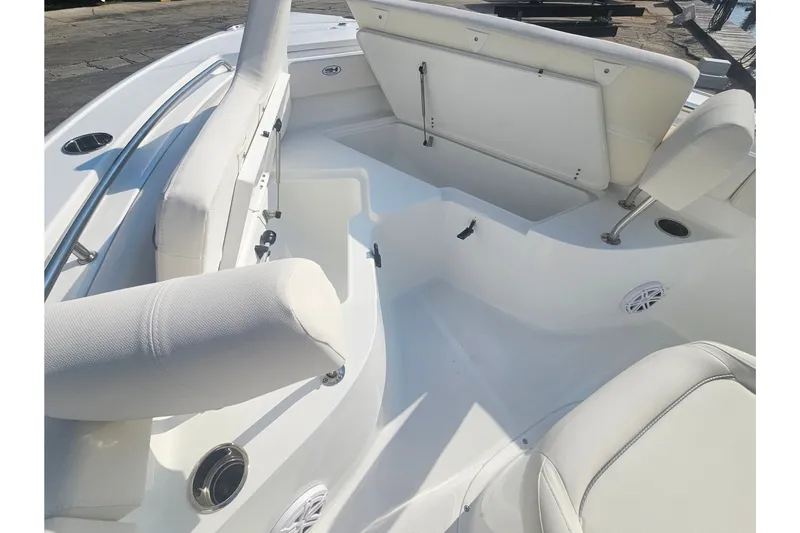 Slide: The Image of Interior view of 2027 Sea Hunt Ultra 219 boat, featuring white seating and storage compartments. - 29