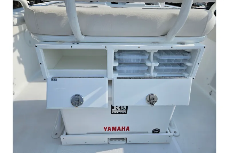 Slide: The Image of Storage compartments on a 2027 Sea Hunt Ultra 219 boat, featuring organized tackle boxes. - 18