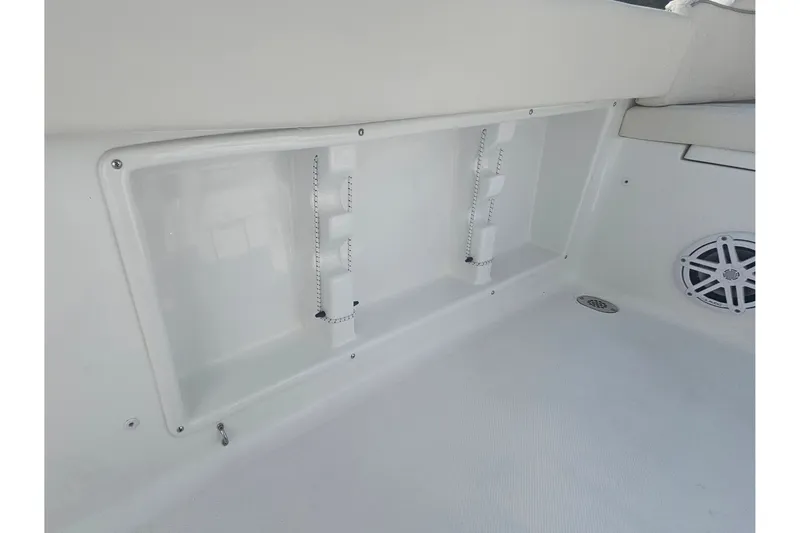 Slide: The Image of Interior view of a 2027 Sea Hunt Ultra 219 boat, featuring storage compartment and speaker. - 34
