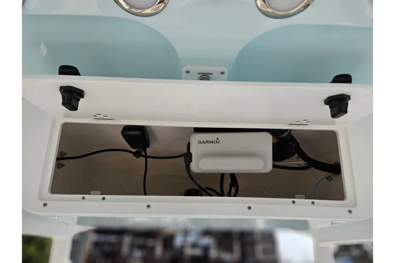 Slide: The Image of 2027 Sea Hunt Ultra 219 boat compartment with Garmin electronics and wiring. - 23