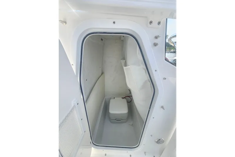 Slide: The Image of Interior view of 2027 Sea Hunt Ultra 219 boat compartment with storage space. - 32