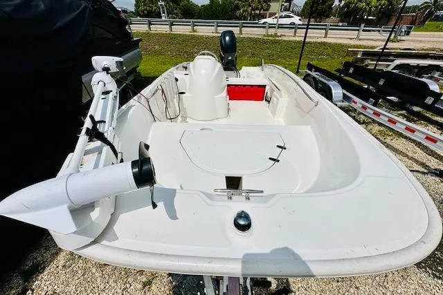 Slide: The Image of 2011 Boston Whaler 170 Super Sport boat, white interior, parked on gravel. - 10