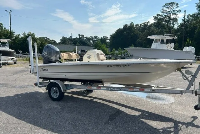 Slide: The Image of 2016 Scout 177 Sport boat on trailer in outdoor setting, side view. - 8