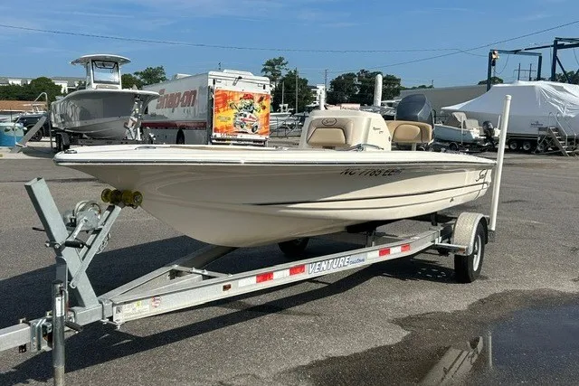 Slide: The Image of 2016 Scout 177 Sport boat on trailer in marina parking lot. - 10