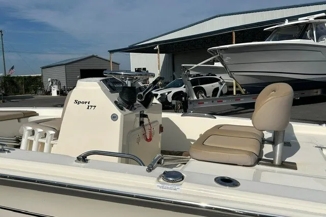 Slide: The Image of 2016 Scout 177 Sport boat with beige seating, docked near a marina. - 3