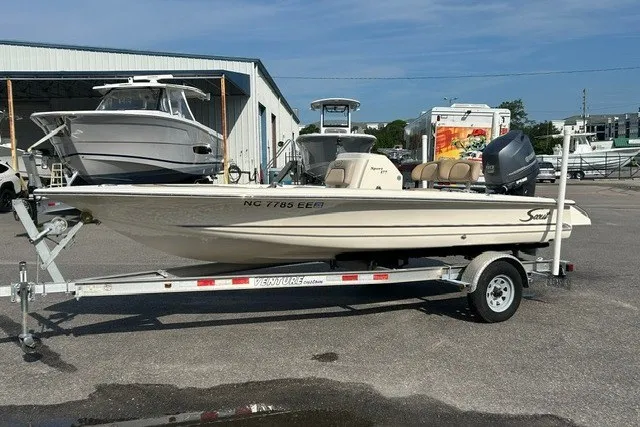 The Image of 2016 Scout 177 Sport boat on trailer in marina parking lot. - 1