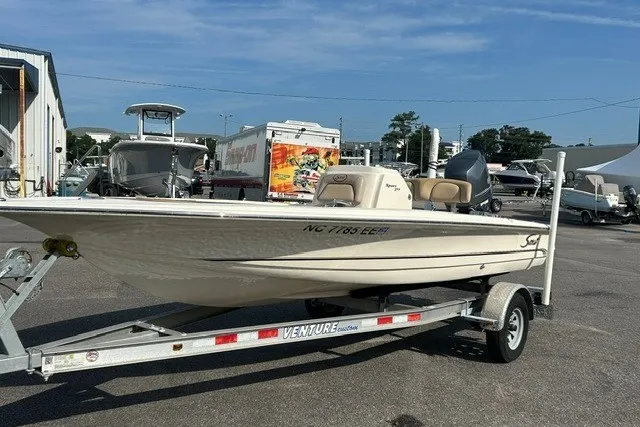 Slide: The Image of 2016 Scout 177 Sport boat on trailer in marina parking lot. - 2
