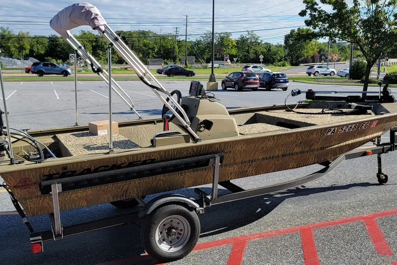 The Image of 2018 Tracker Grizzly 1648 SC boat on trailer in parking lot. - 1