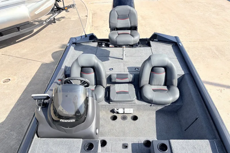 Slide: The Image of 2024 Tracker Pro Team 195 TXW Tournament Edition boat interior with seating and steering console. - 24