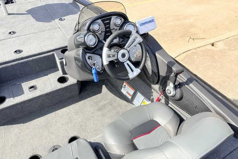 Slide: The Image of 2024 Tracker Pro Team 195 TXW Tournament Edition boat cockpit with steering wheel and controls. - 29