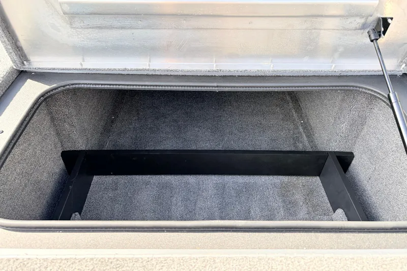 Slide: The Image of Open storage compartment in 2024 Tracker Pro Team 195 TXW Tournament Edition boat. - 18
