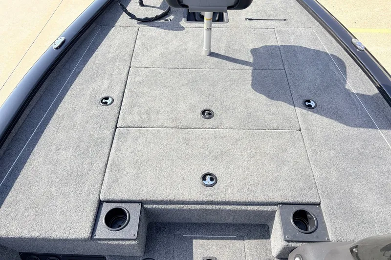 Slide: The Image of 2024 Tracker Pro Team 195 TXW Tournament Edition boat deck with carpeted surface and storage compartments. - 14