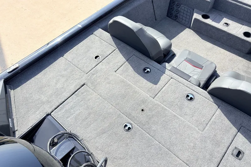 Slide: The Image of 2024 Tracker Pro Team 195 TXW Tournament Edition boat interior with gray carpet and seating. - 37