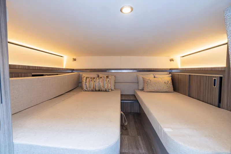 Slide: The Image of Interior of the 2024 Sea Ray Sundancer 320 Outboard with two comfortable beds and stylish lighting. - 18