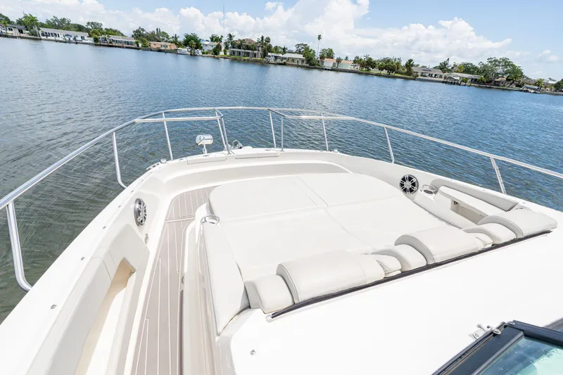 Slide: The Image of The image shows the bow of a 2024 Sea Ray Sundancer 320 Outboard with comfortable lounging areas. - 14