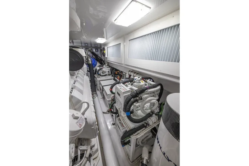Slide: The Image of Engine room of 2025 Viking 58 Convertible yacht, showcasing advanced machinery and clean design. - 60