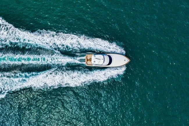Slide: The Image of Aerial view of 2025 Viking 58 Convertible yacht cruising on open water. - 8