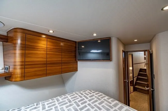 Slide: The Image of Luxurious cabin interior of 2025 Viking 58 Convertible yacht with modern wood finishes. - 47