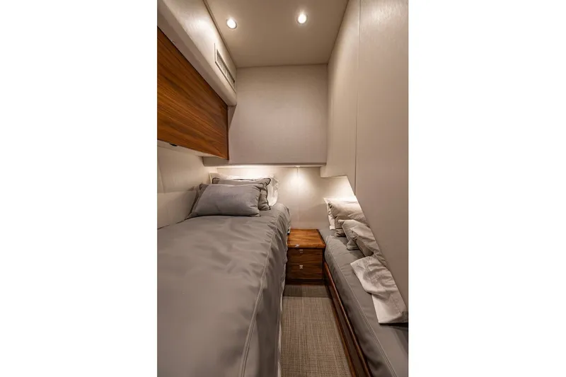 Slide: The Image of Luxurious cabin interior of 2025 Viking 58 Convertible yacht with twin beds and elegant lighting. - 53