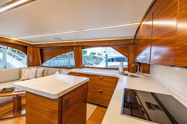 Slide: The Image of Luxurious interior of 2025 Viking 58 Convertible yacht with modern kitchen and seating area. - 37