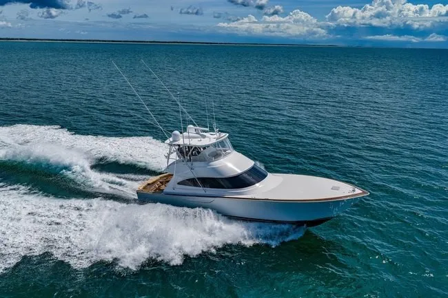 Slide: The Image of 2025 Viking 58 Convertible yacht cruising on open ocean under clear skies. - 9