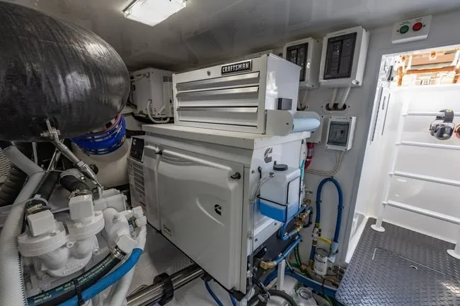 Slide: The Image of Engine room of 2025 Viking 58 Convertible yacht, featuring advanced machinery and equipment. - 55