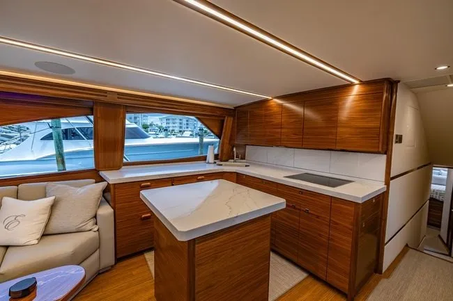 Slide: The Image of Luxurious interior of 2025 Viking 58 Convertible yacht with modern kitchen and seating area. - 40