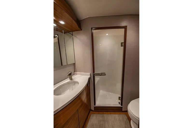 Slide: The Image of Luxurious bathroom interior of 2025 Viking 58 Convertible yacht, featuring modern fixtures and elegant design. - 51