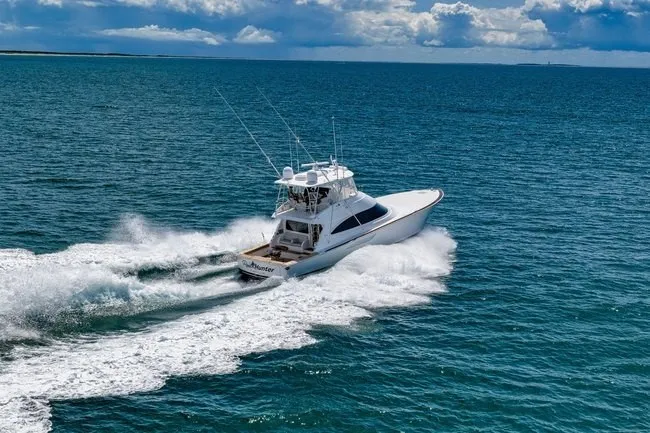 Slide: The Image of 2025 Viking 58 Convertible yacht cruising on open ocean waters. - 11