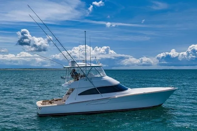 Slide: The Image of 2025 Viking 58 Convertible yacht cruising on open sea under blue sky. - 5