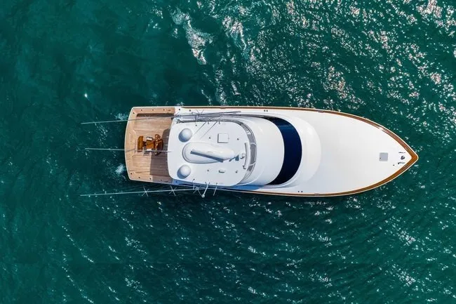 Slide: The Image of Aerial view of 2025 Viking 58 Convertible yacht on turquoise water. - 7