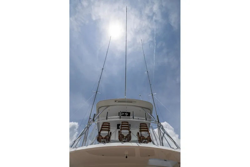 Slide: The Image of 2025 Viking 58 Convertible yacht under a bright sunlit sky. - 36