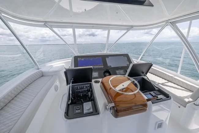 Slide: The Image of 2025 Viking 58 Convertible yacht helm with advanced navigation systems and ocean view. - 17