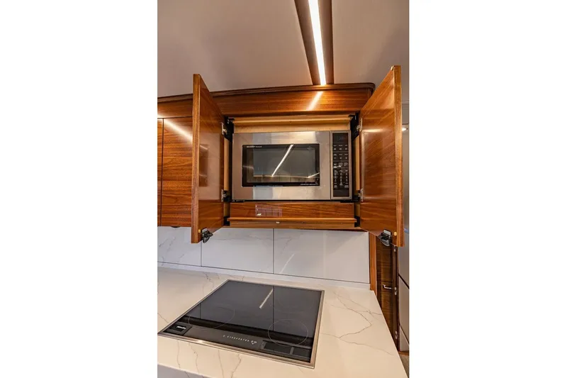 Slide: The Image of Modern kitchen in 2025 Viking 58 Convertible yacht with microwave and induction cooktop. - 41