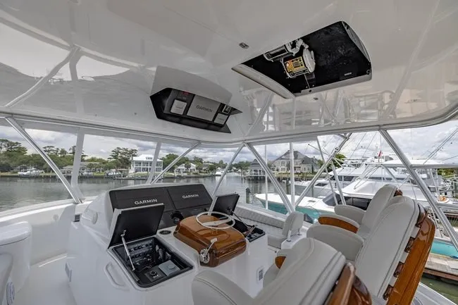 Slide: The Image of 2025 Viking 58 Convertible yacht helm with advanced Garmin navigation systems and luxurious seating. - 1