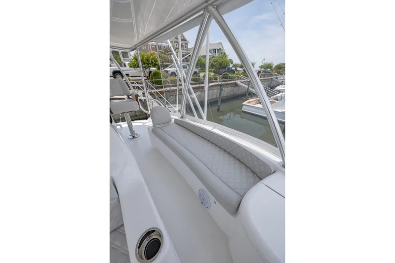 Slide: The Image of 2025 Viking 58 Convertible yacht with sleek seating and marina view. - 25