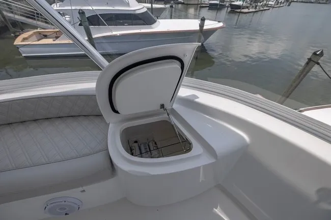 Slide: The Image of 2025 Viking 58 Convertible yacht with open storage compartment, docked at marina. - 23