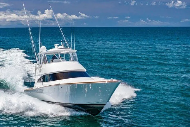Slide: The Image of 2025 Viking 58 Convertible yacht cruising on open ocean under clear skies. - 10