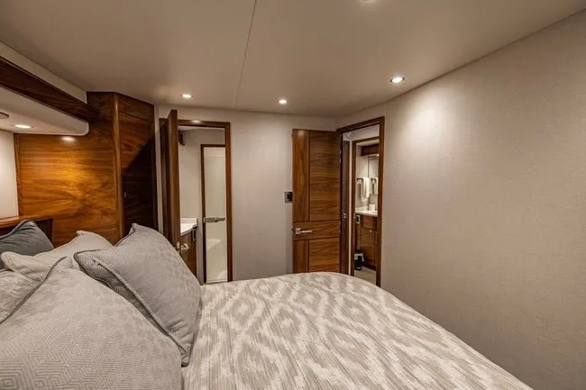 Slide: The Image of Luxurious bedroom interior of 2025 Viking 58 Convertible yacht with elegant wood finishes. - 50