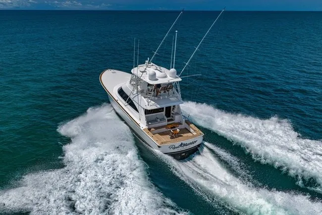 Slide: The Image of 2025 Viking 58 Convertible yacht cruising on open ocean waters. - 12