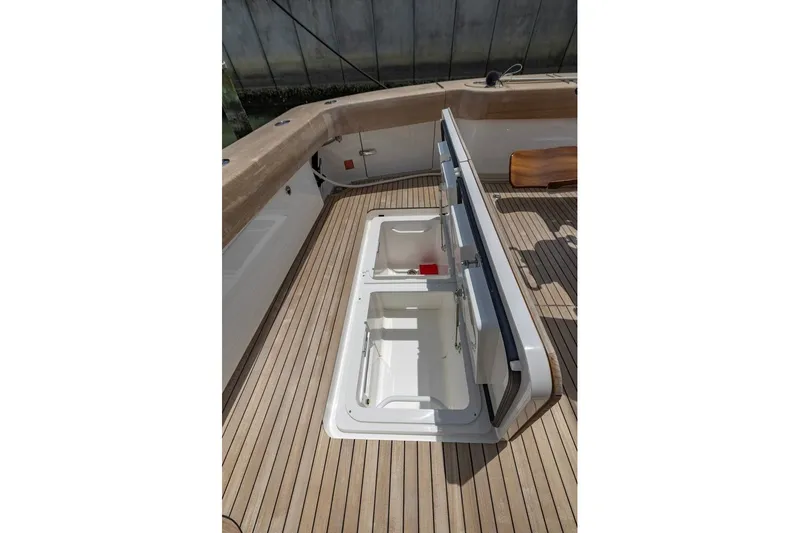 Slide: The Image of Open storage compartments on 2025 Viking 58 Convertible yacht deck. - 34