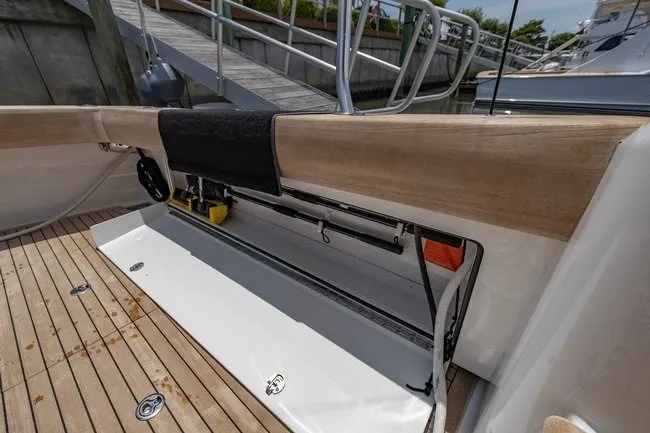 Slide: The Image of 2025 Viking 58 Convertible yacht deck with storage compartment and wooden flooring. - 33