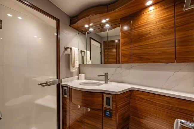 Slide: The Image of Luxurious bathroom in 2025 Viking 58 Convertible yacht with elegant wood cabinetry and modern fixtures. - 49